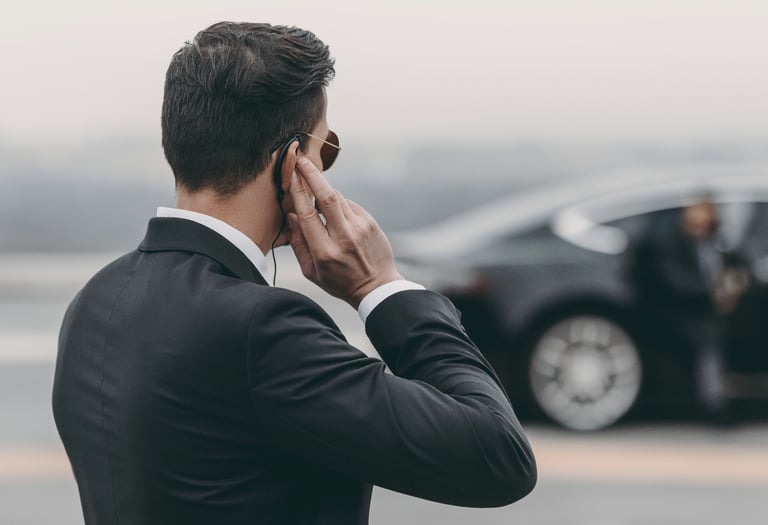 a man in a suit and tie is talking on the phone
