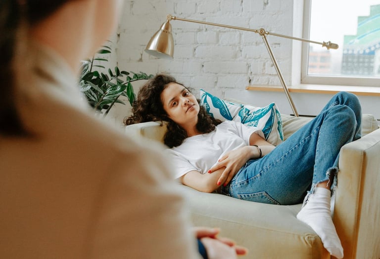 a woman sitting on a couch in a living room