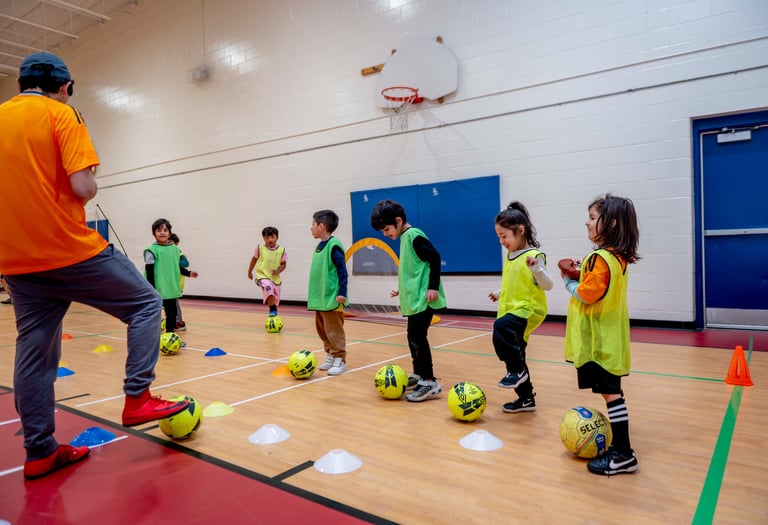 Young children MVB FC students practicing soccer ball control drills during an indoor Mississauga