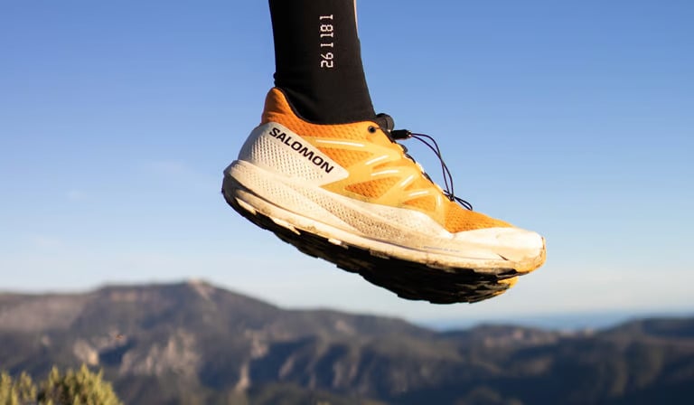 a person's feet in the air with a pair of socks on