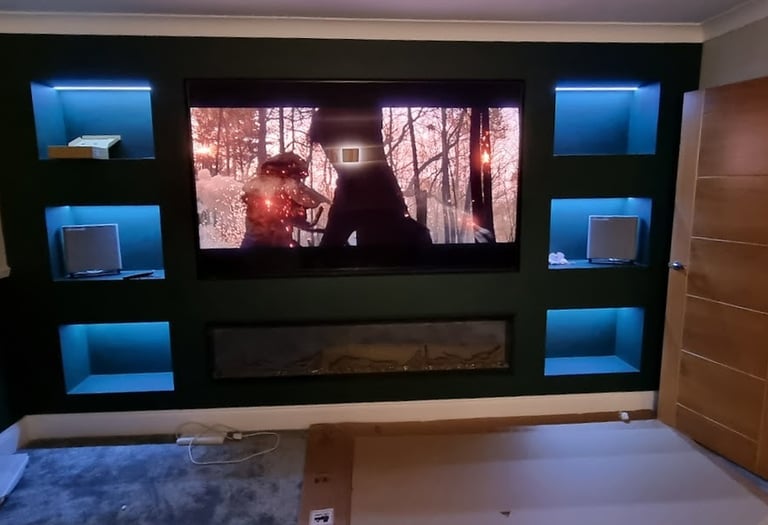 Luxury bespoke media wall featuring ambient LED lighting and professional TV mounting.