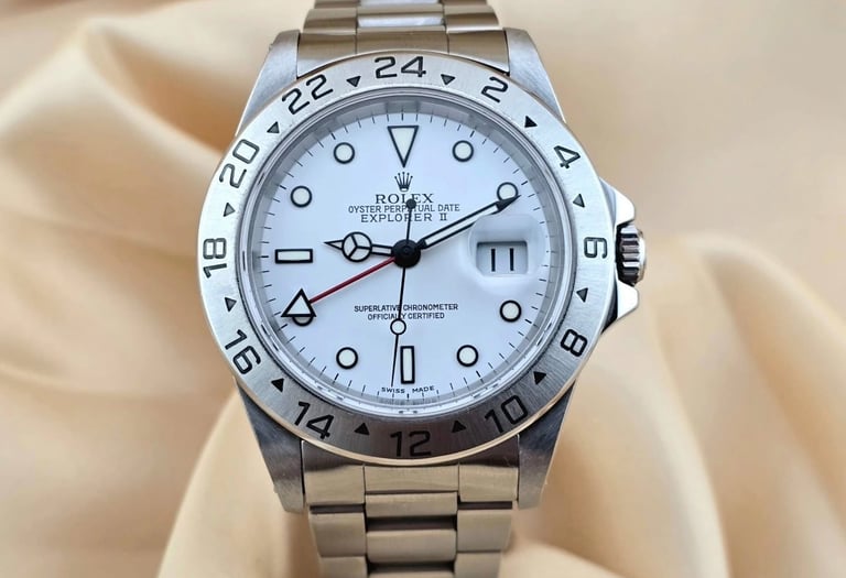 Luxury Rolex Explorer II luxury watch with a white polar dial and stainless steel oyster bracelet.