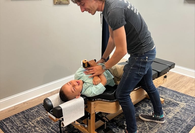 Child receiving chiropractic adjustment for sensory processing issues