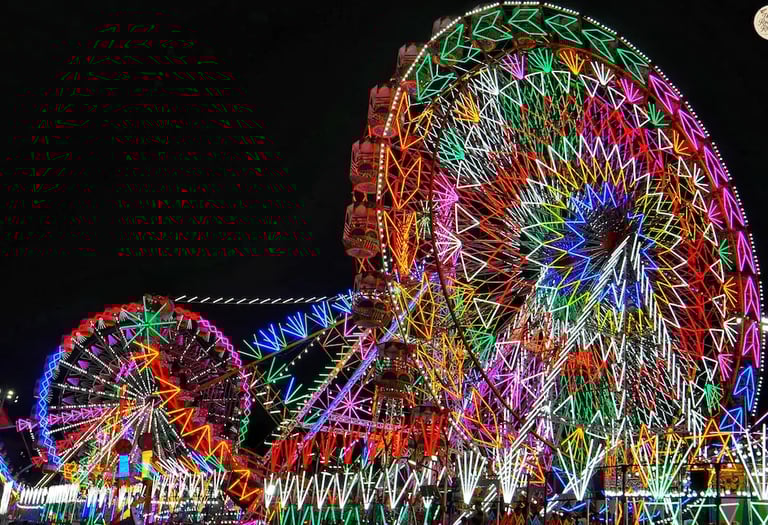 Amusement rides glowing with colorful carnival lights at Kota Dussehra Mela night view.