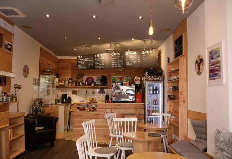 a cafe with a small table and chairs