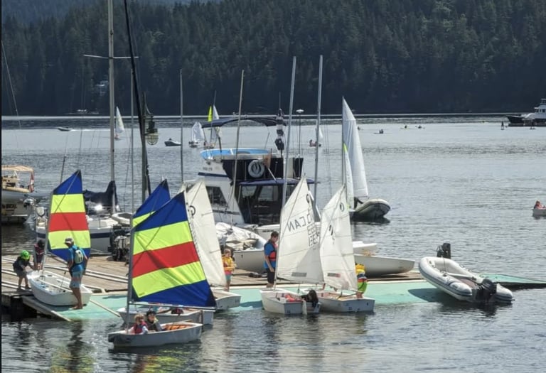 An image of opti sailboats at a sailing summer camp in Deep Cove, North Vancouver, BC