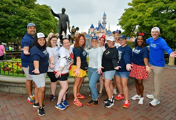 Minnie's Travel Boutique pictured in front of Sleeping Beauty Castle inside Disneyland® Park.