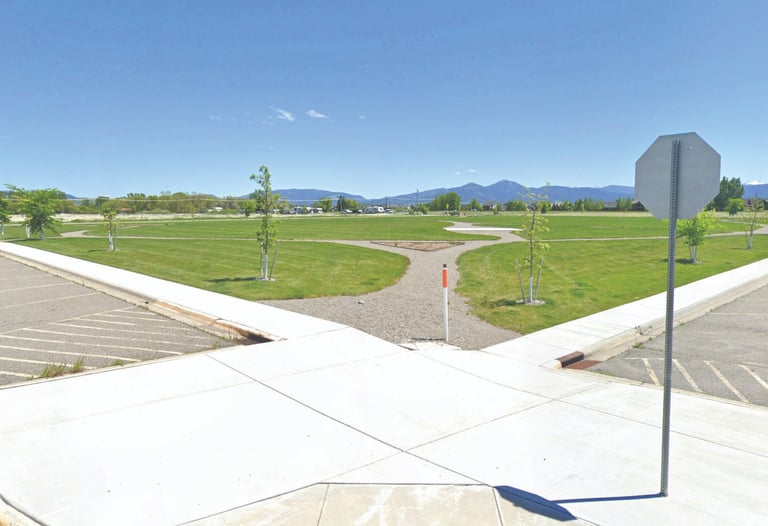 a stop sign on a street corner with a view of mountains in the background