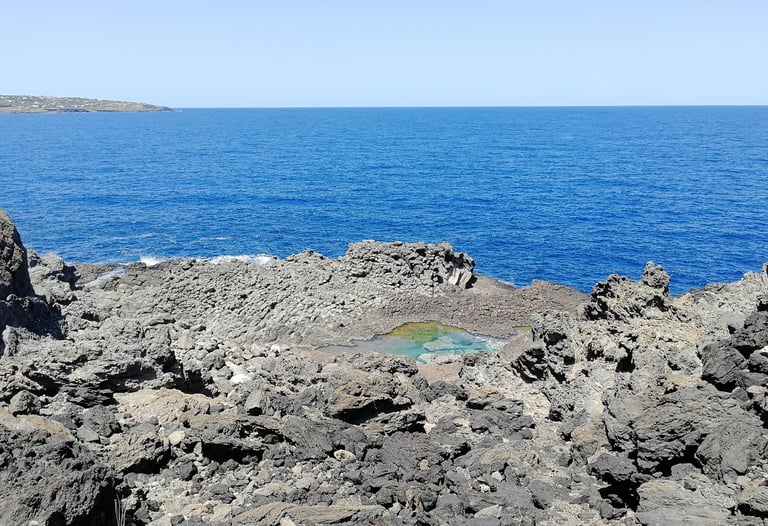 Laghetto delle Ondine in Pantelleria, natural saltwater pool among volcanic rocks and sea