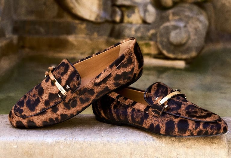 Luxury leopard print loafers with gold hardware detail by Tod's.