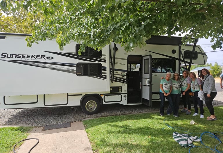 group of ladies in front of RV in matching shirts for their trip