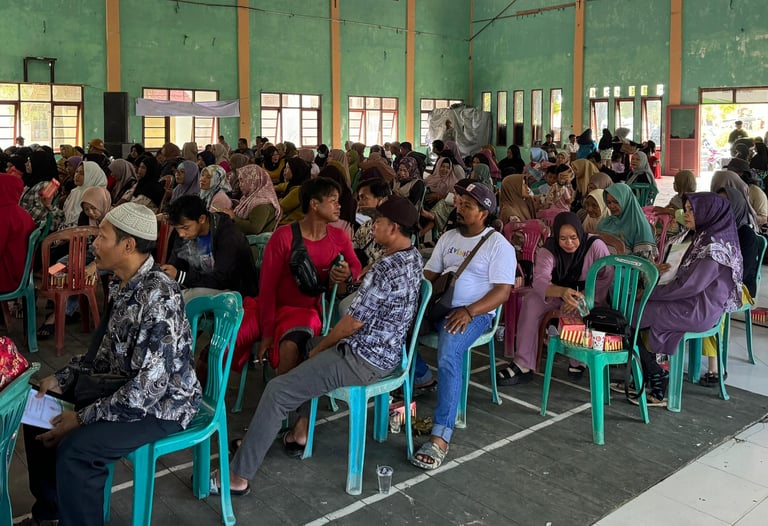 a large group of people sitting in chairs in a room