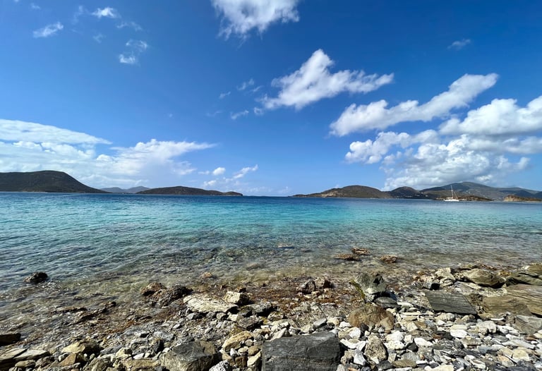 a view of a Virgin Islands rocky beach with a clear blue sky