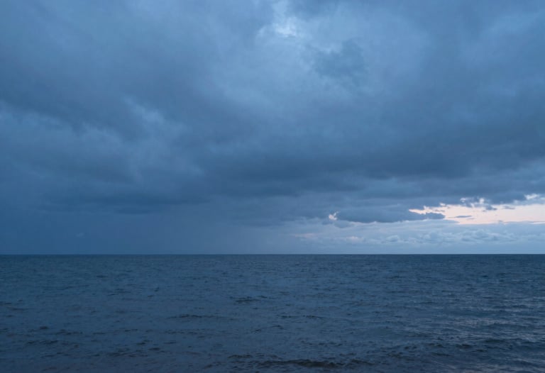 A peaceful Baltic coastline during the blue hour, representing the vastness of human emotion and the possibility of calm after a storm.