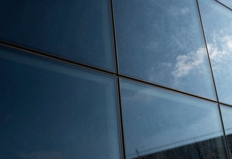 Abstract photography of light reflecting on glass, shades of deep navy and steel blue, symbolizing clarity and analysis.