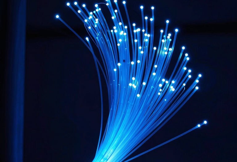 Abstract photography of fiber optic cables glowing in bright blue within a dark navy infrastructure environment. High-speed data transmission concept.