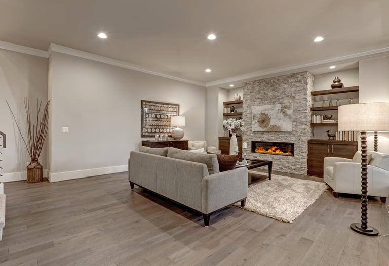 Newly finished basement with luxury vinyl flooring, recessed lighting and electric heat fireplace