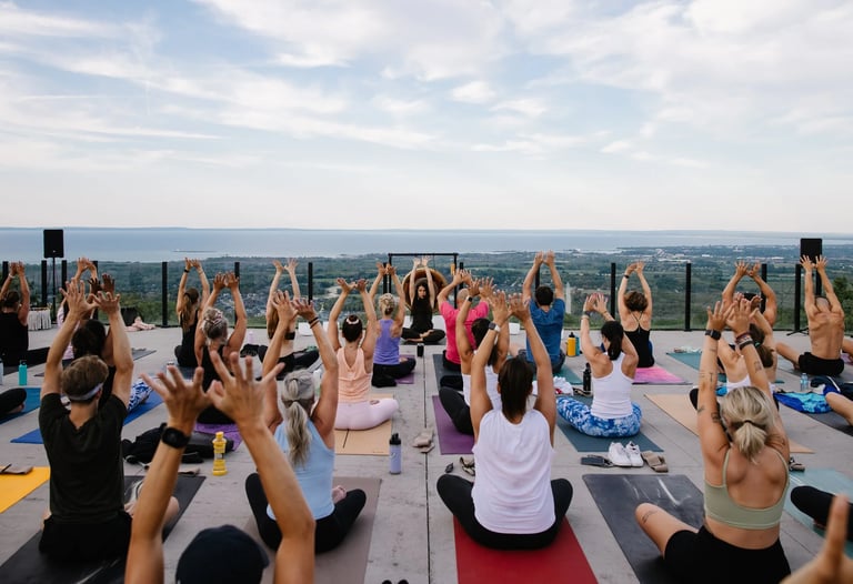 People practice yoga outdoors at sunset, at Everlove festival