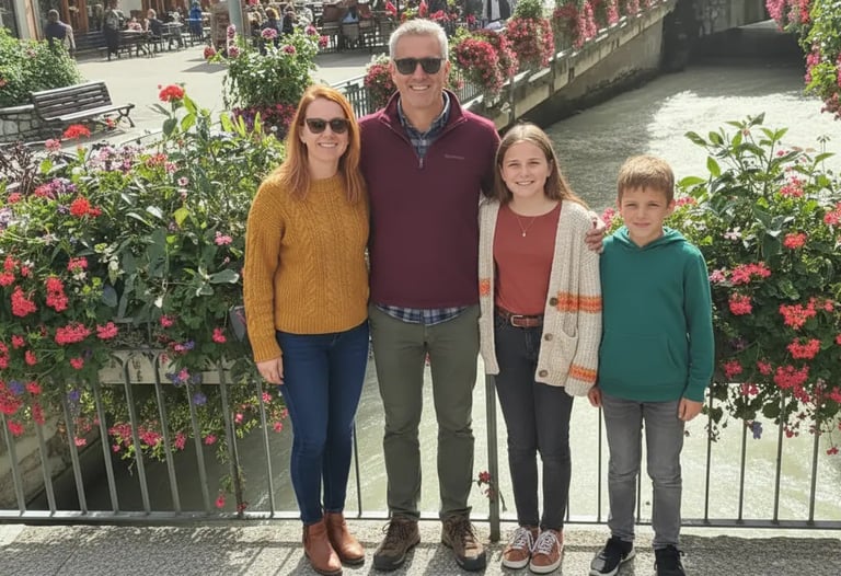 Family standing on a bridge in Chamonix town center with flowers, enjoying a sightseeing stop on a M