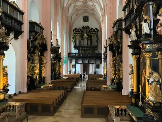 The ornate baroque interior of a traditional church in Salzburg.