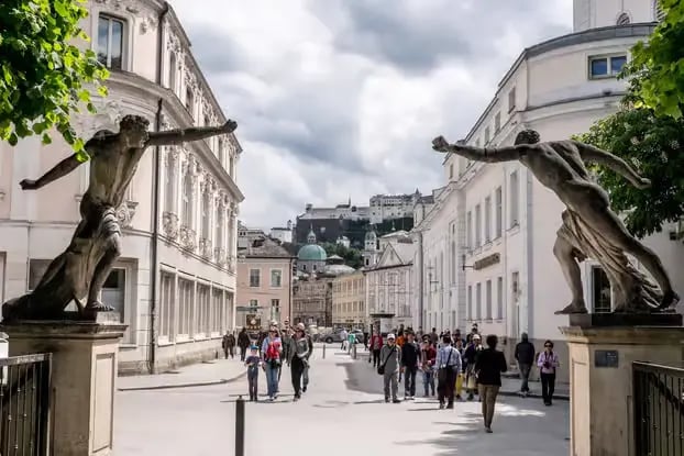 Mirabell Gardens entrance statues with Hohensalzburg Fortress view