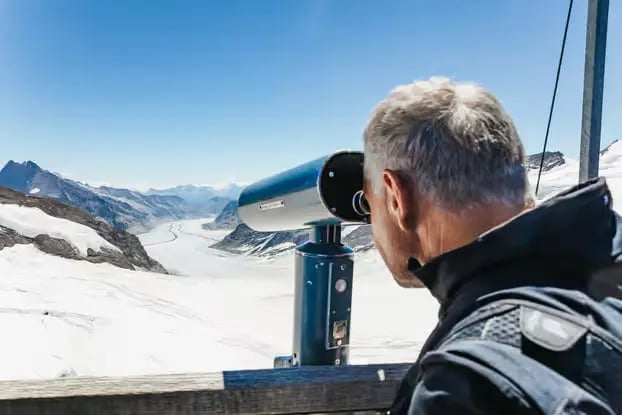 Close-up of tourist using telescope at Sphinx Terrace Jungfraujoch Swiss Alps