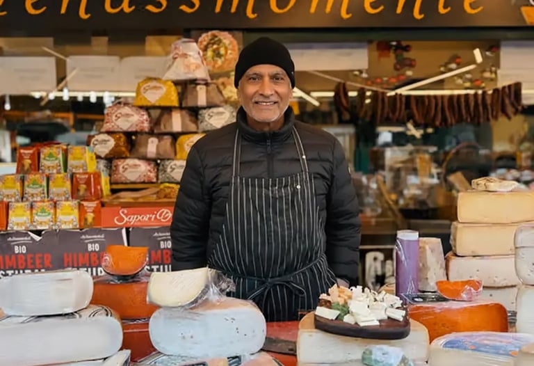 Local vendor with artisanal cheeses at Naschmarkt VIENNA FOOD SPOTS.