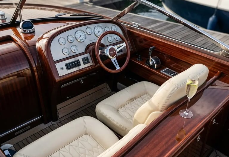 Riva Aquariva polished mahogany dashboard with cream leather seat and prosecco glass at dock