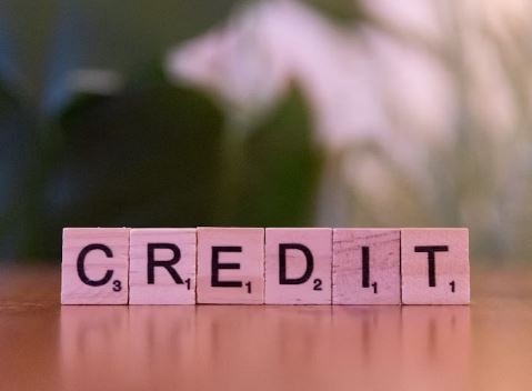 a wooden block with the words credit card on it