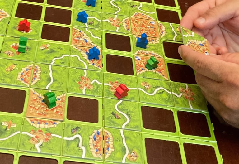 Getting ready to play a tile in Carcassonne the game
