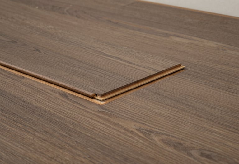 A close-up of premium wooden flooring installation in a high-end South Asian / Indian residence, showing the quality of joinery and the rich muted brown finish.
