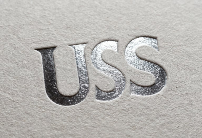 Detailed shot of a textured paper surface with a sharp, silver foil embossed logo under bright studio lighting, sophisticated and premium, North American / US.