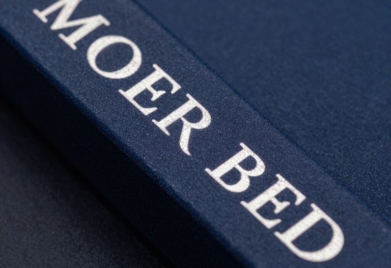 Macro photography of an elegant book spine with silver foil lettering against a dark blue background. Professional studio lighting.