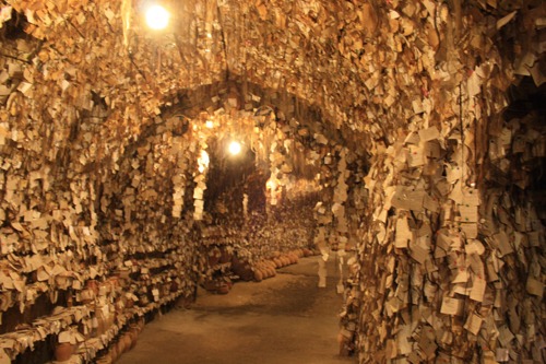 The interior of the Avanos Hair Museum in Turkey, featuring thousands of hair samples and notes on cave walls.