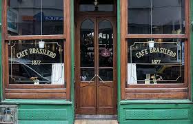 Classic wooden storefront of Cafe Brasilero in Montevideo, established in 1877.