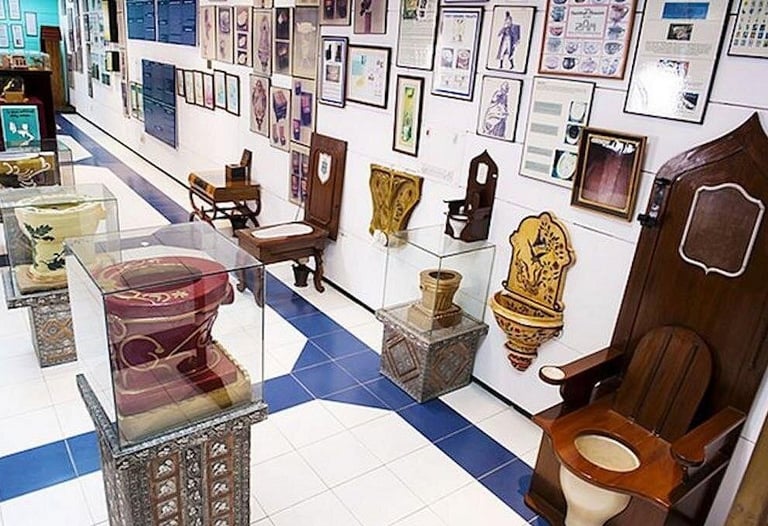 Sulabh International Museum of Toilets exhibition featuring historic wooden latrines and ornate ceramic commodes.