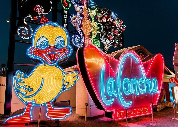 Vintage neon signs including a yellow duck and La Concha Motel sign at the Neon Museum in Las Vegas.