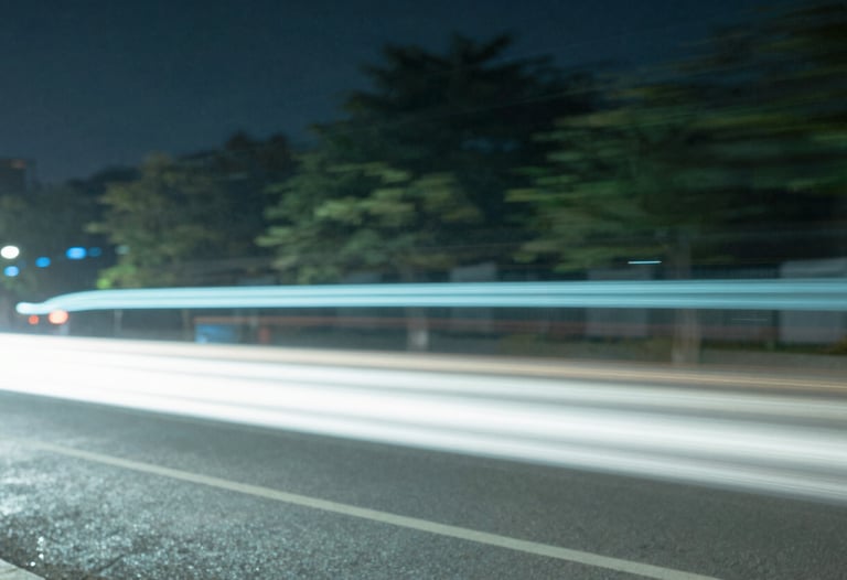 Abstract slow shutter photography of city lights at night, creating light trails in pale blue and sage green, high-concept aesthetic.