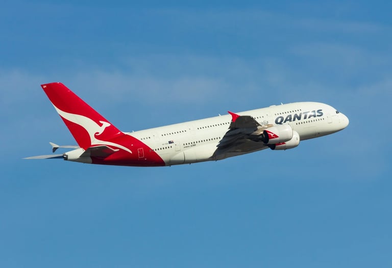 red and white air plane in mid air during daylight