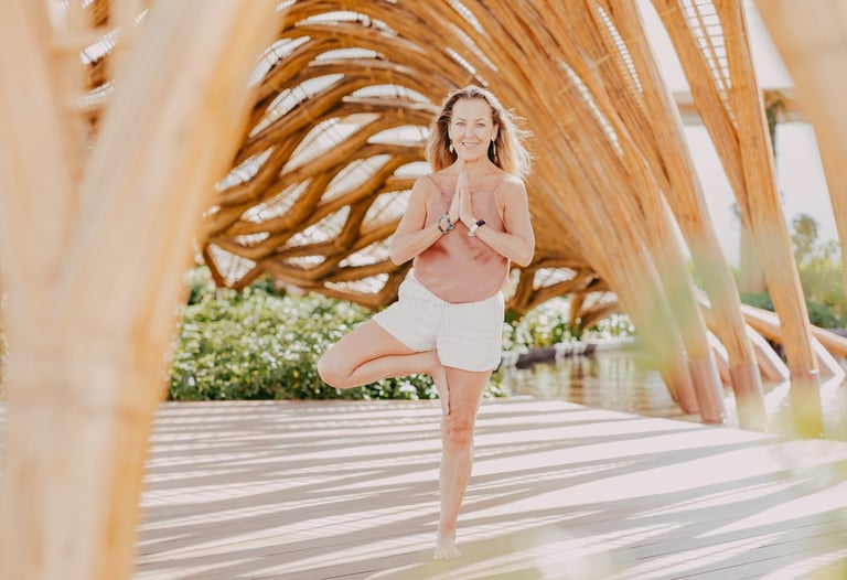a woman in a yoga pose in Akumal Mexico