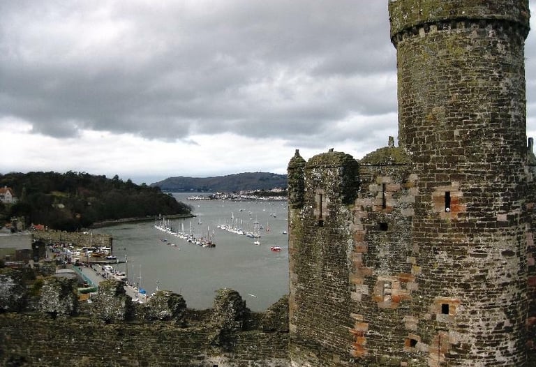 Welsh castle overlooking river and boats in circle
