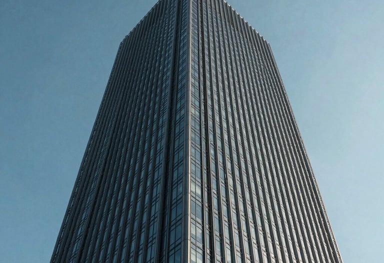 A low-angle shot of a sleek corporate skyscraper against a clear, cool blue sky. The architecture is glass and steel, reflecting a sense of power and stability.