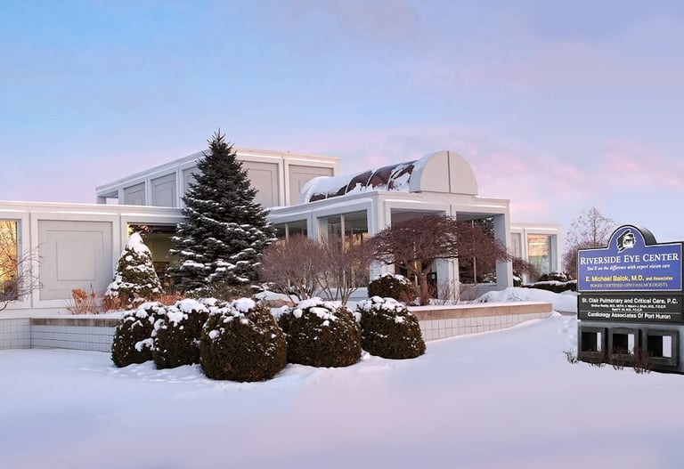 office building with snow covered trees