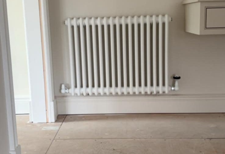 double-panel radiator being leveled and tested by PBP Services in Pershore
