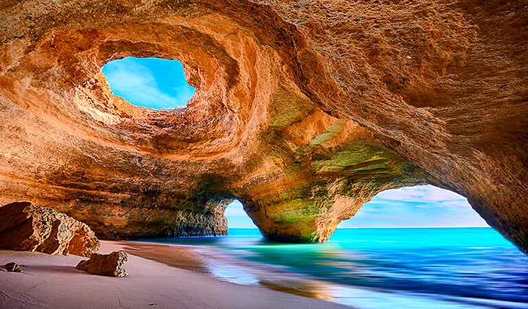 a cave in a cave with a view of the ocean