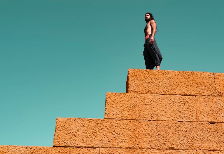 a man standing on a brick wall 