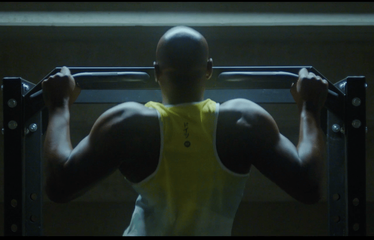 black man doing pull-ups
