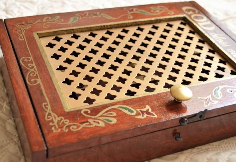 a wooden box with a golden handle