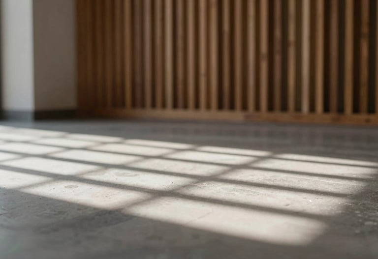 Interior shot of a cultural hall with wooden slats casting intricate shadows on a stone floor, using #D9D2C7 and #2F2E2E, very sophisticated and clean.