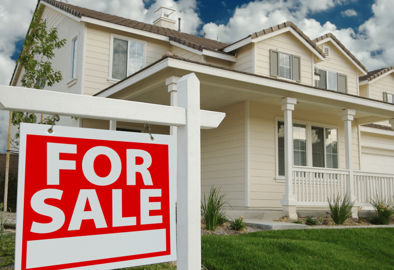 white house with for sale sign